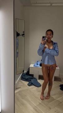 Tattooed legs spread wide in unbuttoned shirt 😈
