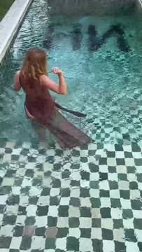 Hot off the press rare find Wet dress hugs her curves walking into pool