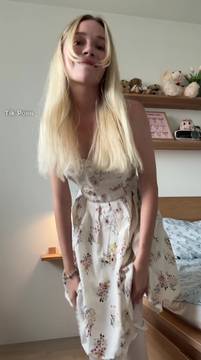 Removing my white thigh-high socks in a pretty floral dress