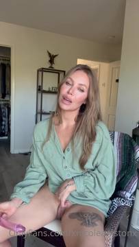Feeling so horny in my chair wearing a green shirt with my glass dildo